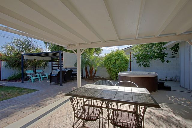 Covered patio dining next to the hot tub