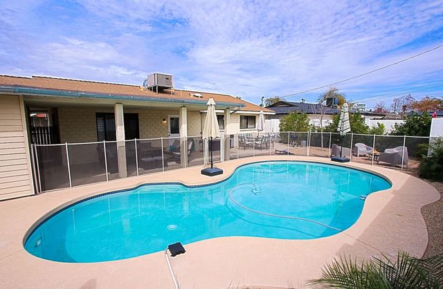 Gated play pool with covered patio behind it