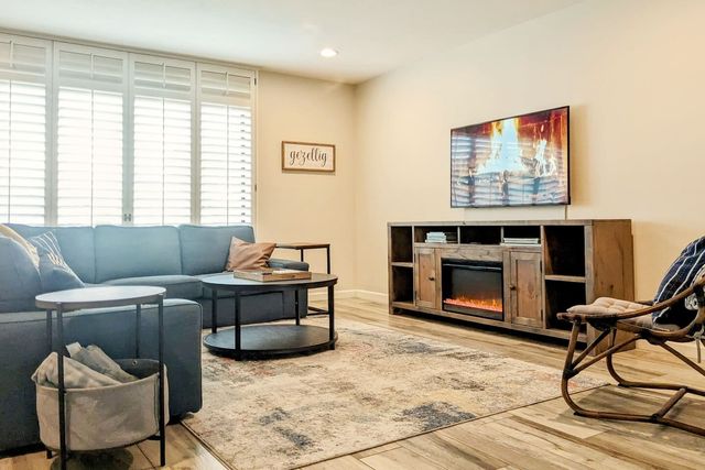 Living room with sectional sofa, TV and electric fireplace